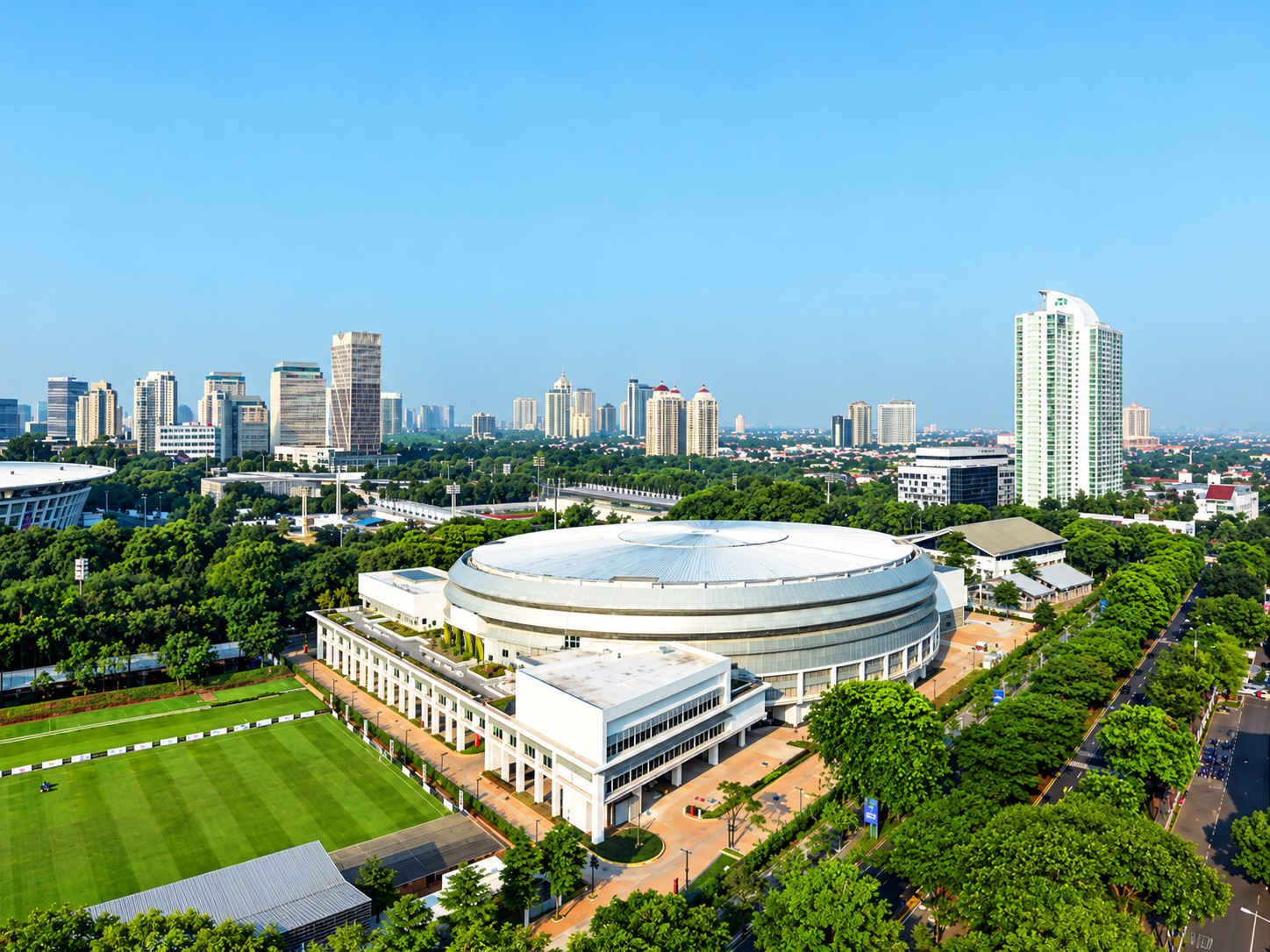 Aerial View of Modern Circular Arena and City Skyline.png