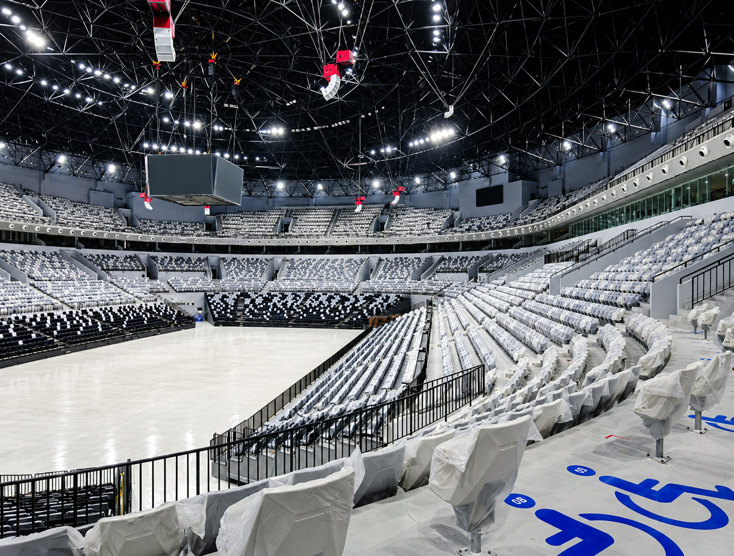 Empty Arena with Wrapped Seats and Scoreboard.png